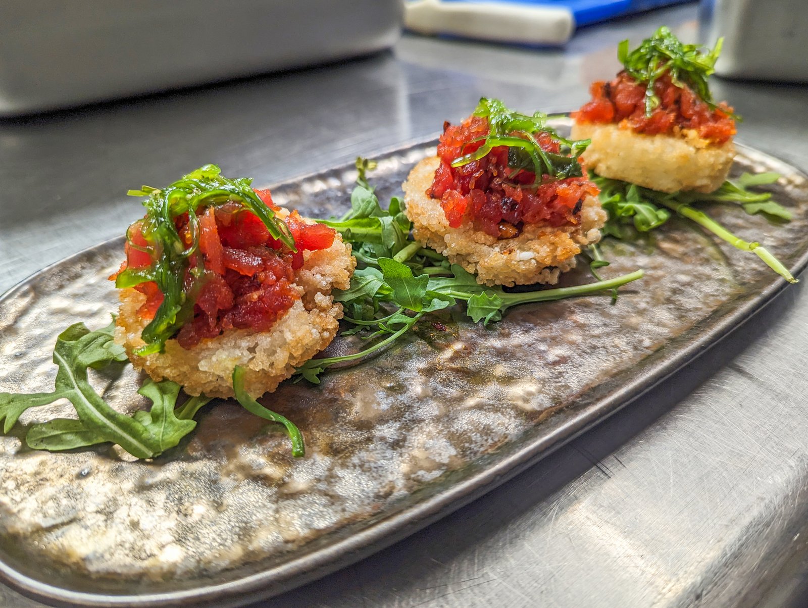 Pan-seared salmon over carrot purée with snap peas and microgreens